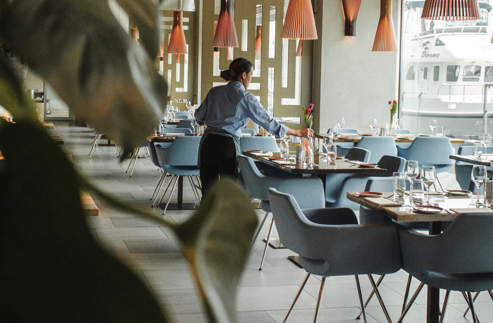 server cleaning off tables a yacht club restaurant