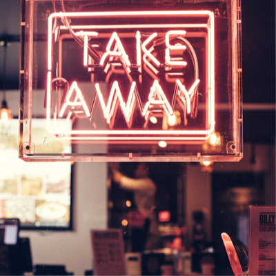 neon take away sign in window of restaurant