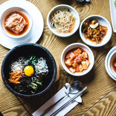korean meal spread with bibimbap and kimchi dishes