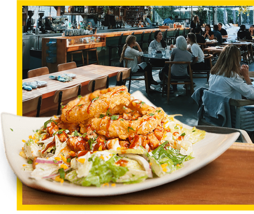 a plate of food in the forground with a restaurant dining room in the background