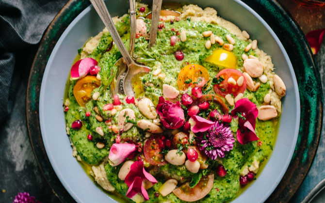 an interesting and colorful food dish. it's green and has flowers.